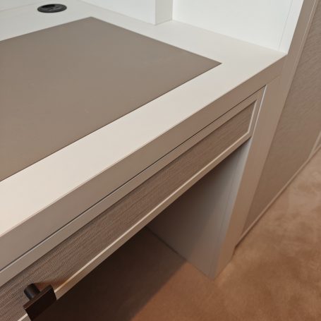 White Grey wardrobe and desk with leather insert Corner of a modern desk showing a smooth grey surface and clean lines.