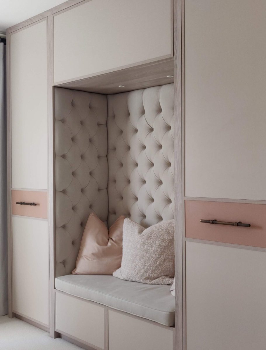 A modern, stylish nook with padded walls and cushions in soft, neutral tones.