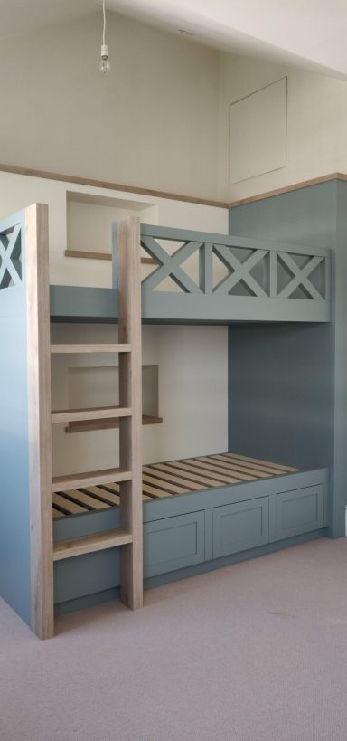 Fjord Green and Oak bunk beds Bunk bed with a blue and wood finish, featuring a ladder and an open bottom space.