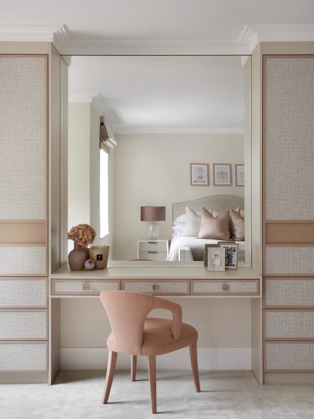 Sand Beige dressing table. Wallpapered doors with integrated handles A stylish bedroom with a mirror, soft-toned chair, and decorative elements.