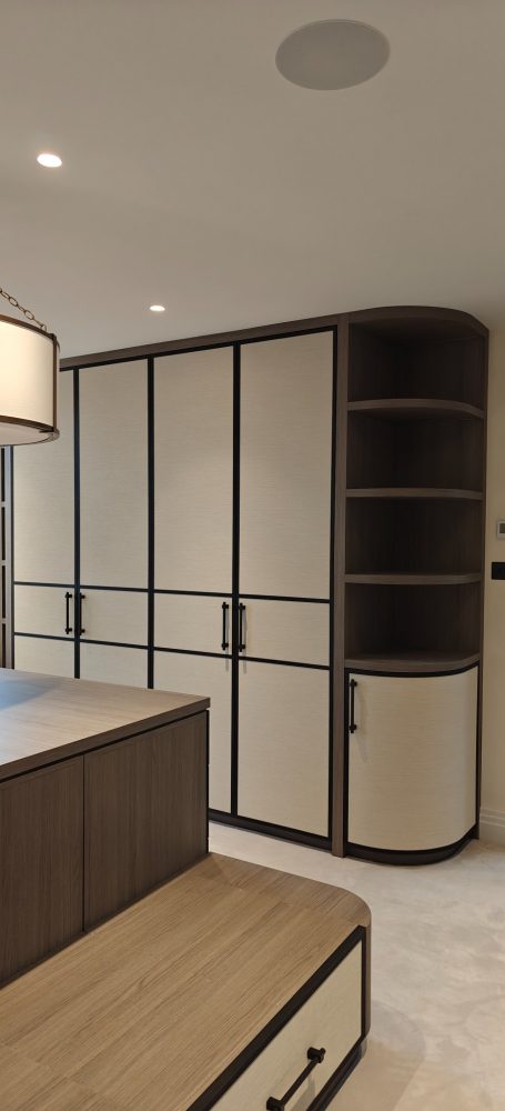 Grey Vicenza Oak dressing room doors with wallpapered panels Modern interior featuring a stylish cabinetry unit in neutral tones and curved design.