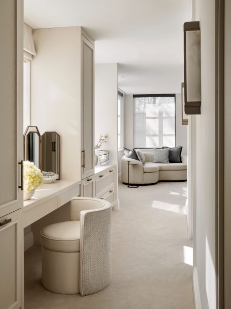 Cremé Beige dressing table Bright, modern hallway leading to a cozy lounge area with elegant furniture.