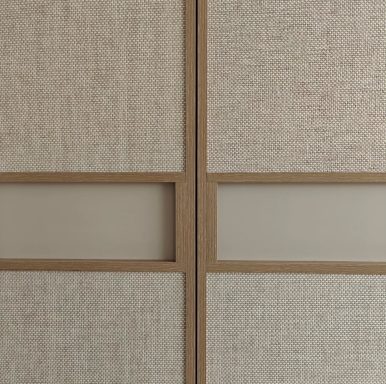 Textured wall panels with wooden framing and subtle glass inserts.