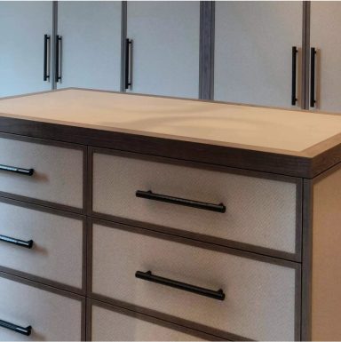 Wooden dresser with six drawers, minimalist design, and black handles.