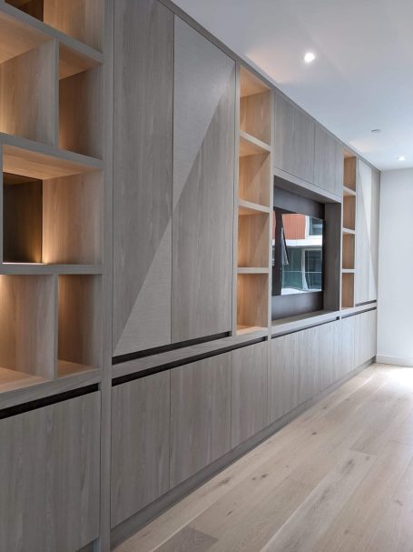 Tivoli and bronze media unit, open shelving with LED's Modern wooden wall unit with shelves and integrated television, featuring minimalist design.