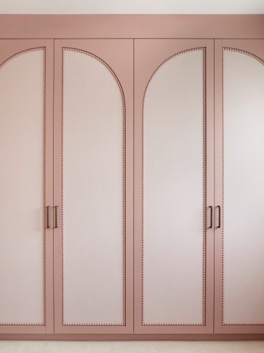 Antique Rose wardrobe doors with bobble beading. Pink wardrobe with three arched doors and metal handles.