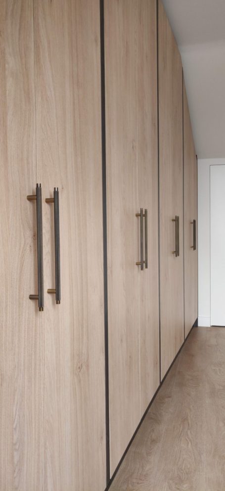 Natural Kendal Oak fitted wardrobe handles Wooden wardrobe with sleek handles and a light wood finish.